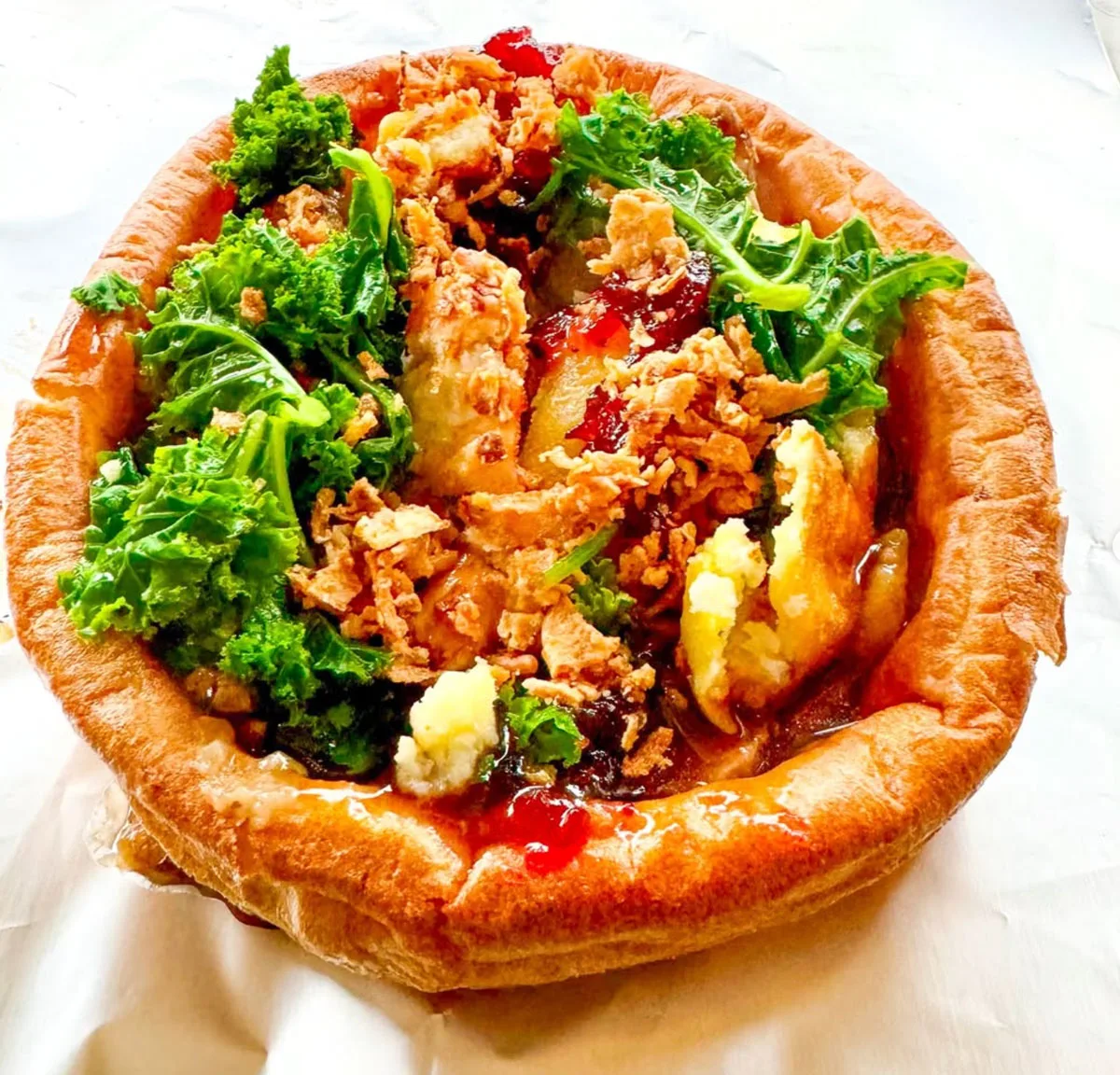 A festive open Yorkshire pudding filled with roast dinner trimmings