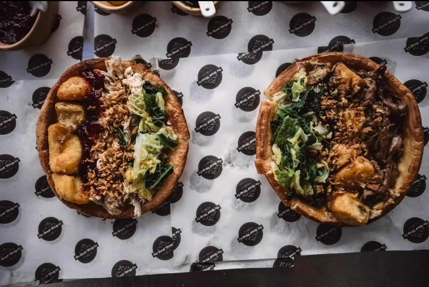 Two generous roast-style dishes ready to serve at a wedding celebration